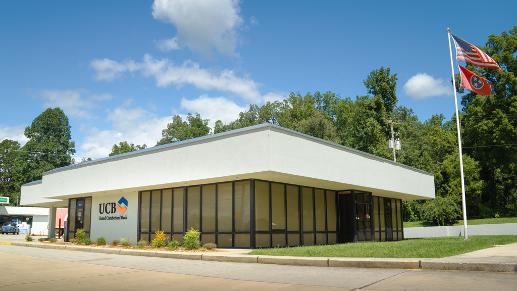 Exterior of the Huntsville branch, all glass building with grey flat roof.