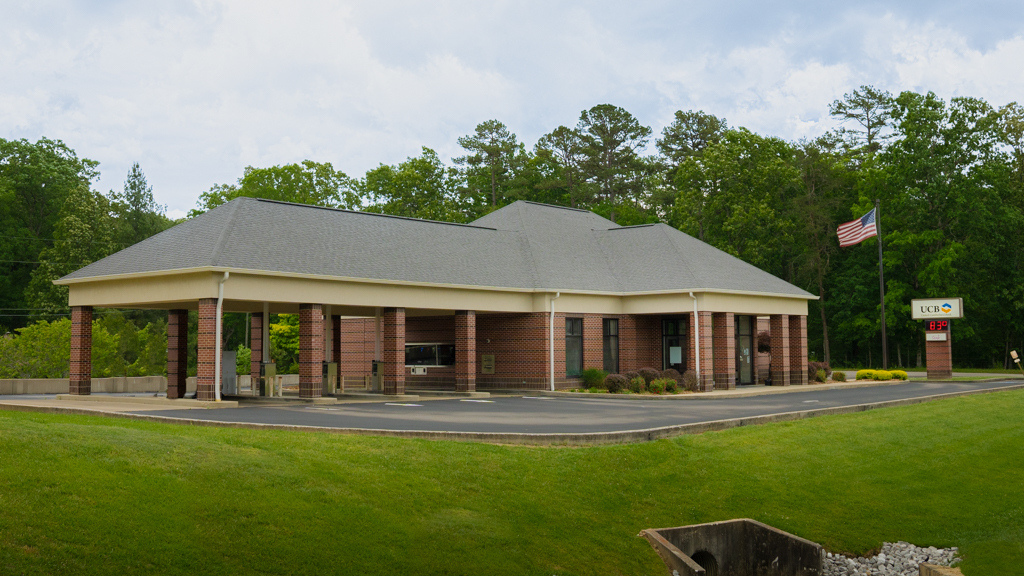 Brick exterior of Pine Knot Office front and side of building with drive up.
