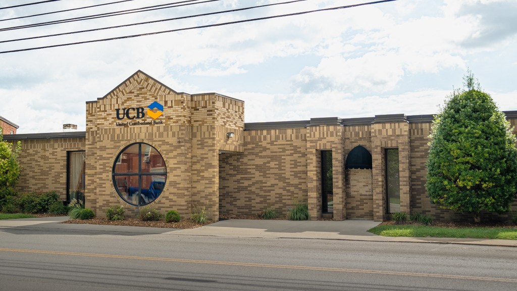 Beige brick front of the UCB main office building.
